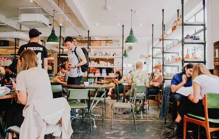 A photo of a busy coffee shop taken by Toa Heftiba on Unsplash