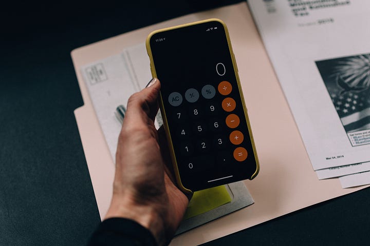A photo of a phone calculator taken by Kelly Sikkema on Unsplash