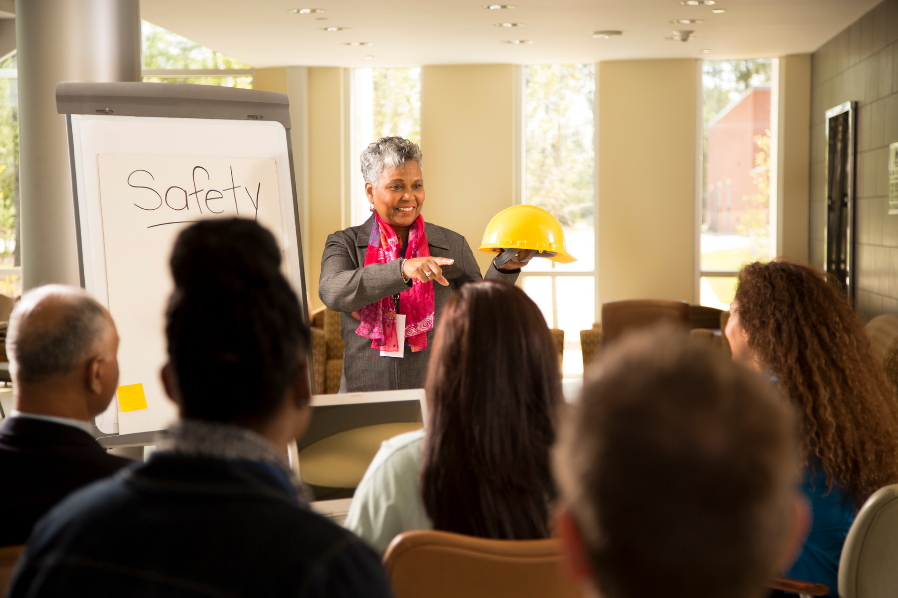 Manager conducting workplace safety meeting