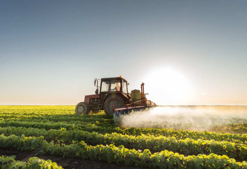 a tractor spraying pesticide on a field