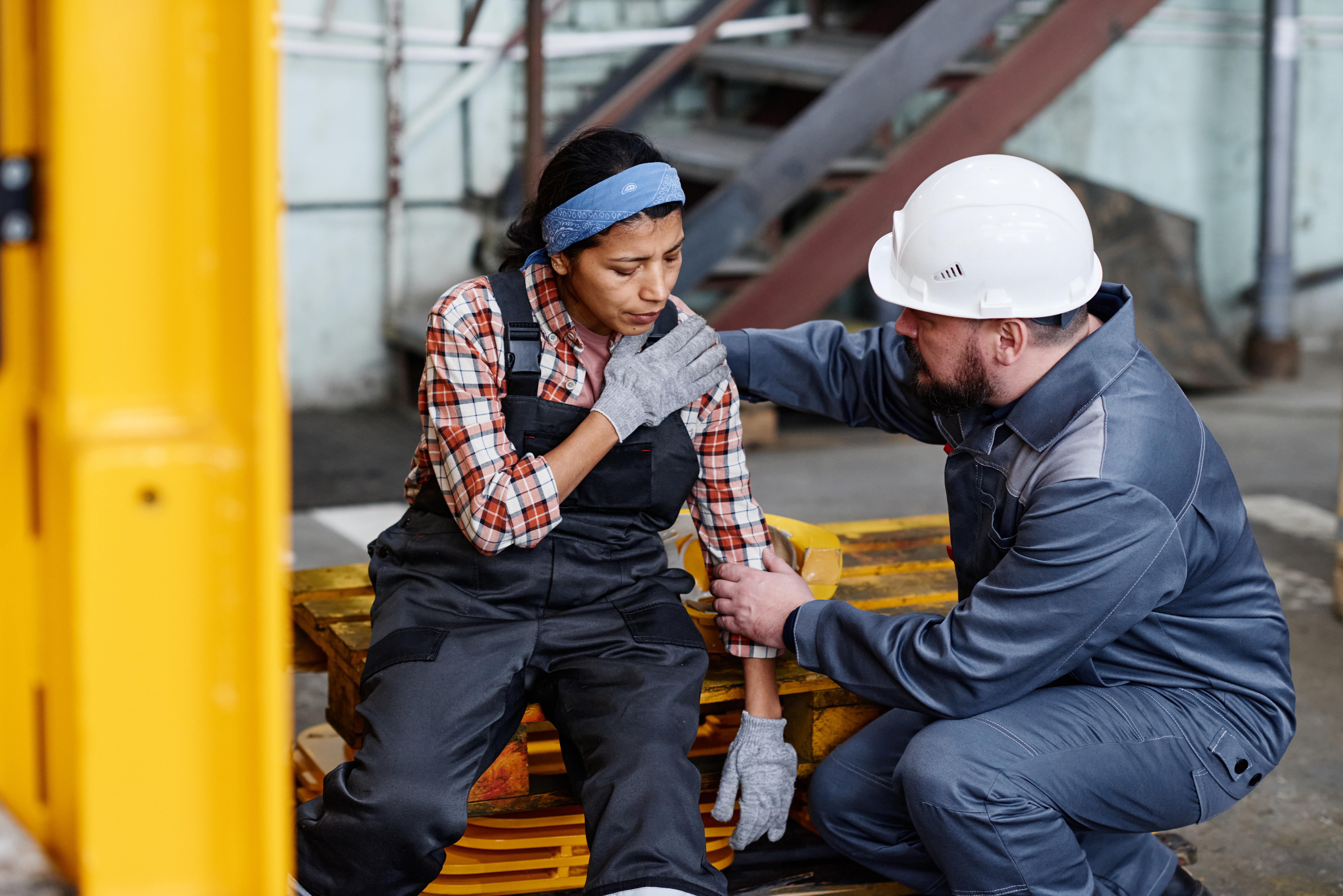 Injured employee being checked on by coworker